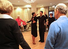 Marina Gando and Luis PeÃ±a teach attendees to waltz.