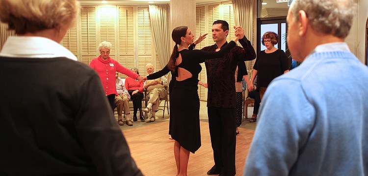 Marina Gando and Luis PeÃ±a teach attendees to waltz.