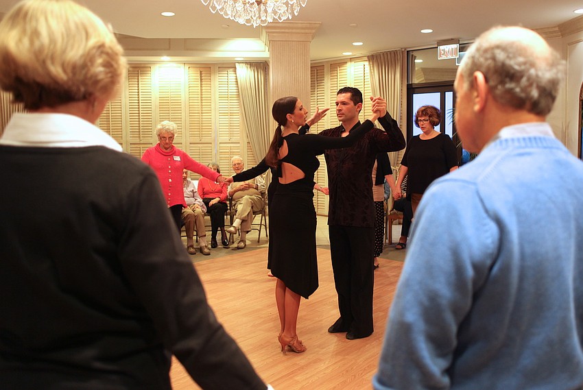 Marina Gando and Luis PeÃ±a teach attendees to waltz.
