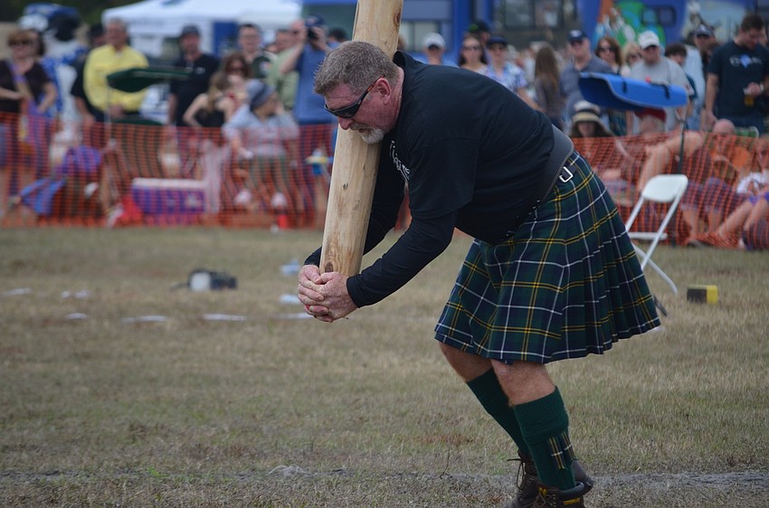 David Turnbull runs with the caber.
