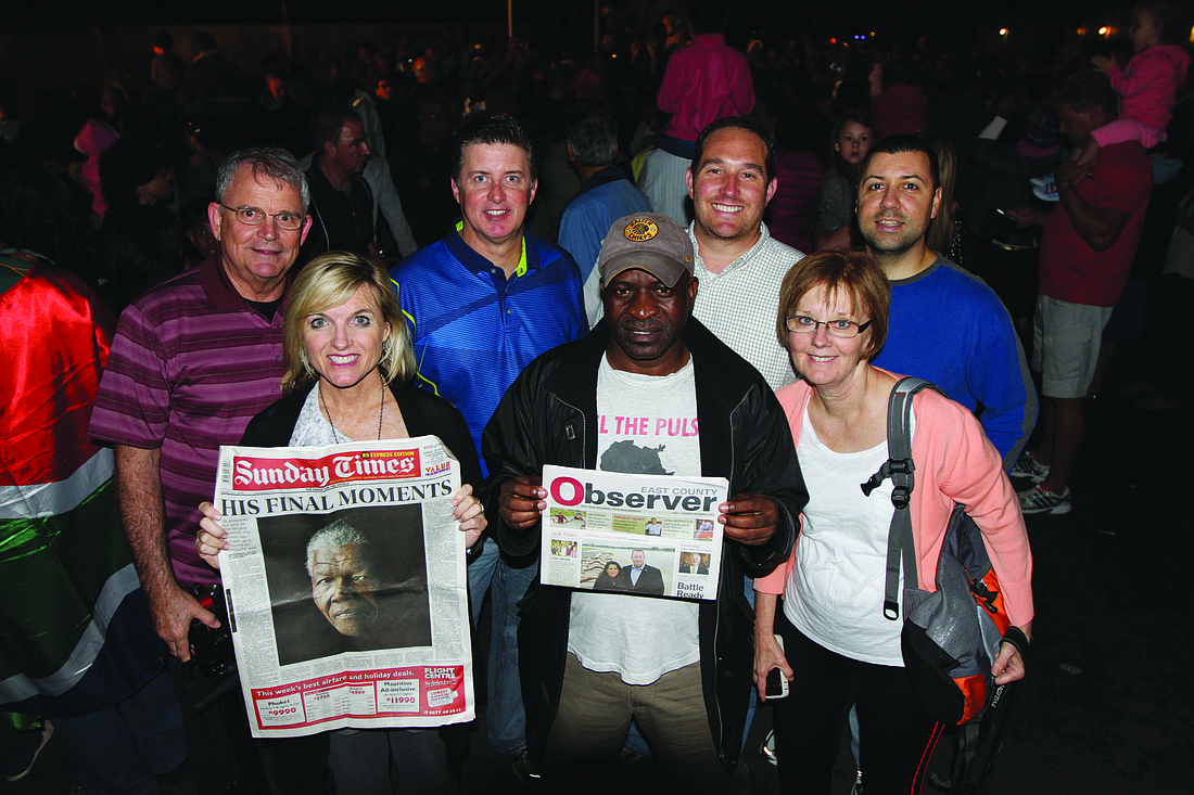 Don Champion, the Rev. Gregg Ellery, the Rev. Craig King and the Rev. Mark Childers (back row) and Valerie Ellery and Marsha Champion (front row) switched newspapers with taxi driver Ali (front row, center) near Johannesburg, South Africa.