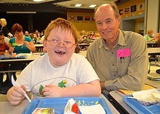 Seven-year-old Dylan McClintock enjoys eggs with his grandfather Don Gilmore.