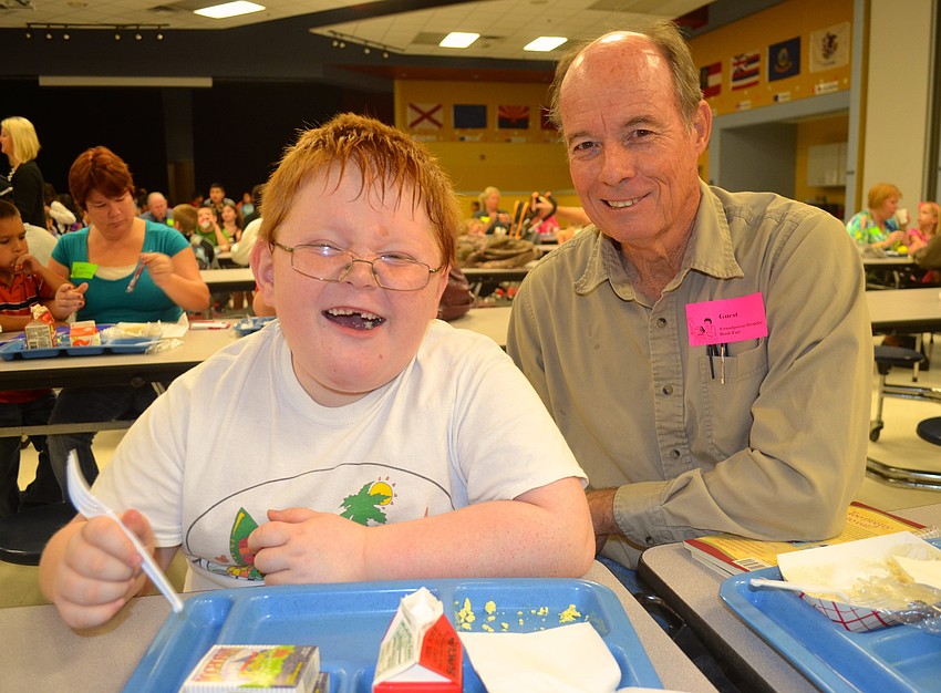 Seven-year-old Dylan McClintock enjoys eggs with his grandfather Don Gilmore.