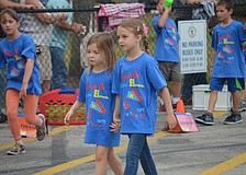 Aubrey Mocherman and Emilia Marr hold hands while walking.