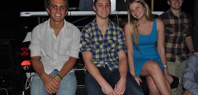 Kevin Berkenbusch, Alec Puhalovich, Ashlyn Falahee and Bryan Dexter found a seat on the back of a pickup truck.