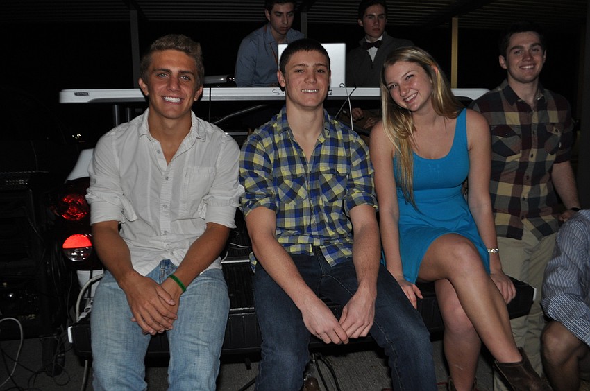 Kevin Berkenbusch, Alec Puhalovich, Ashlyn Falahee and Bryan Dexter found a seat on the back of a pickup truck.