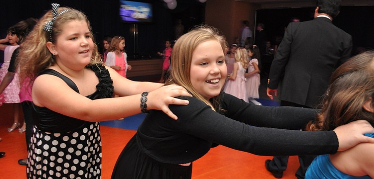 Madison Hartwig and Christian Mark join a conga line.