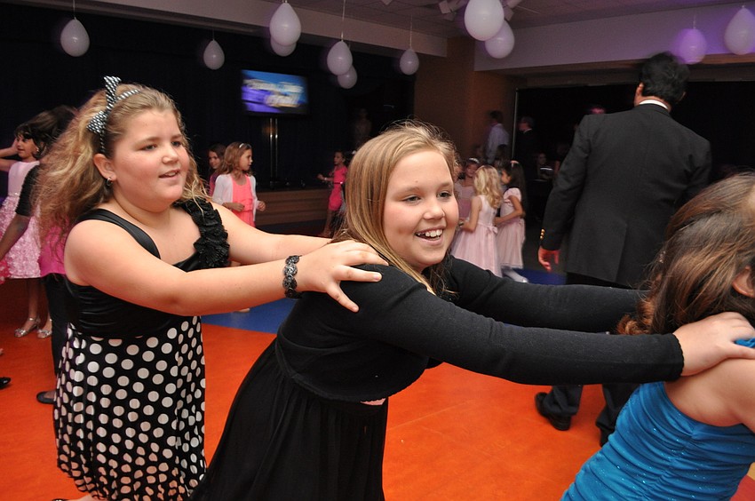 Madison Hartwig and Christian Mark join a conga line.