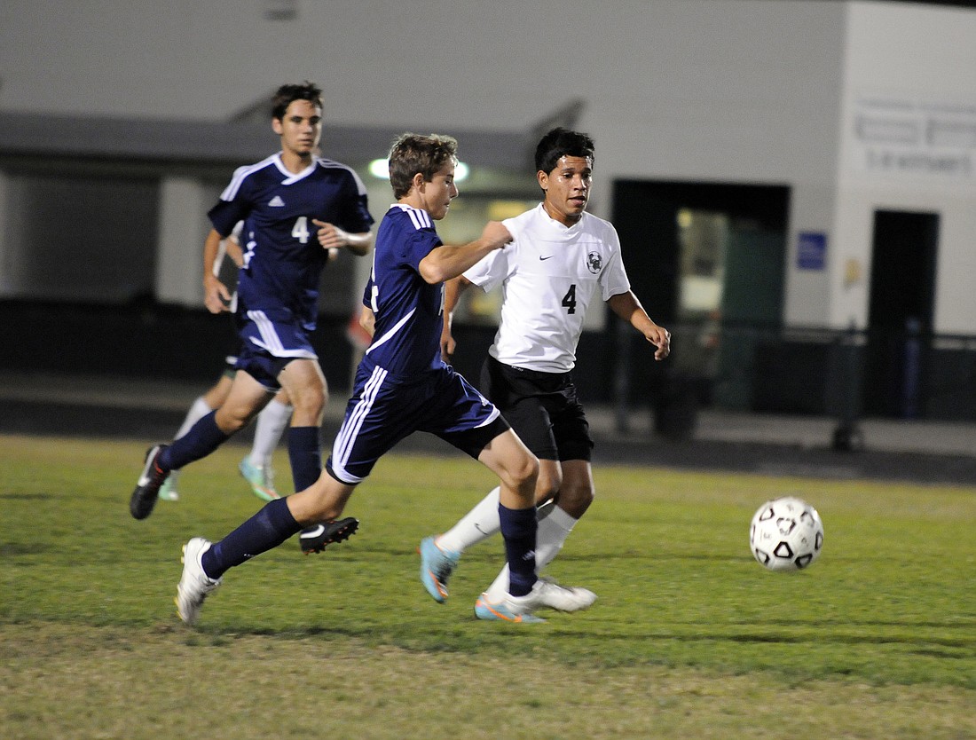 Photos by Jen Blanco Lakewood Ranch's Martin Martinez fights a North Port defender for possession Feb. 7.