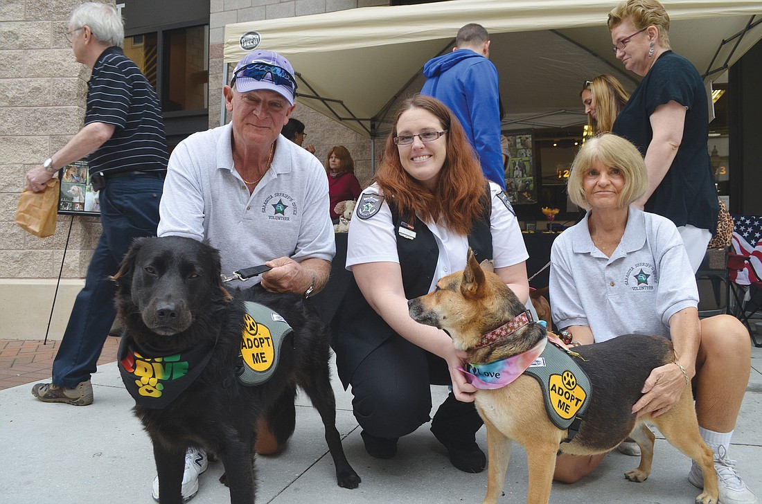 Kristen Little, center, with volunteers Chuck and Joan Stahlman at an adoption event in downtown Sarasota. The Sarasota County shelter holds adoption events weekly.