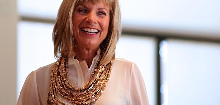 Karen MacIntosh smiles in her special Chicoâ€™s Black Label outfit.