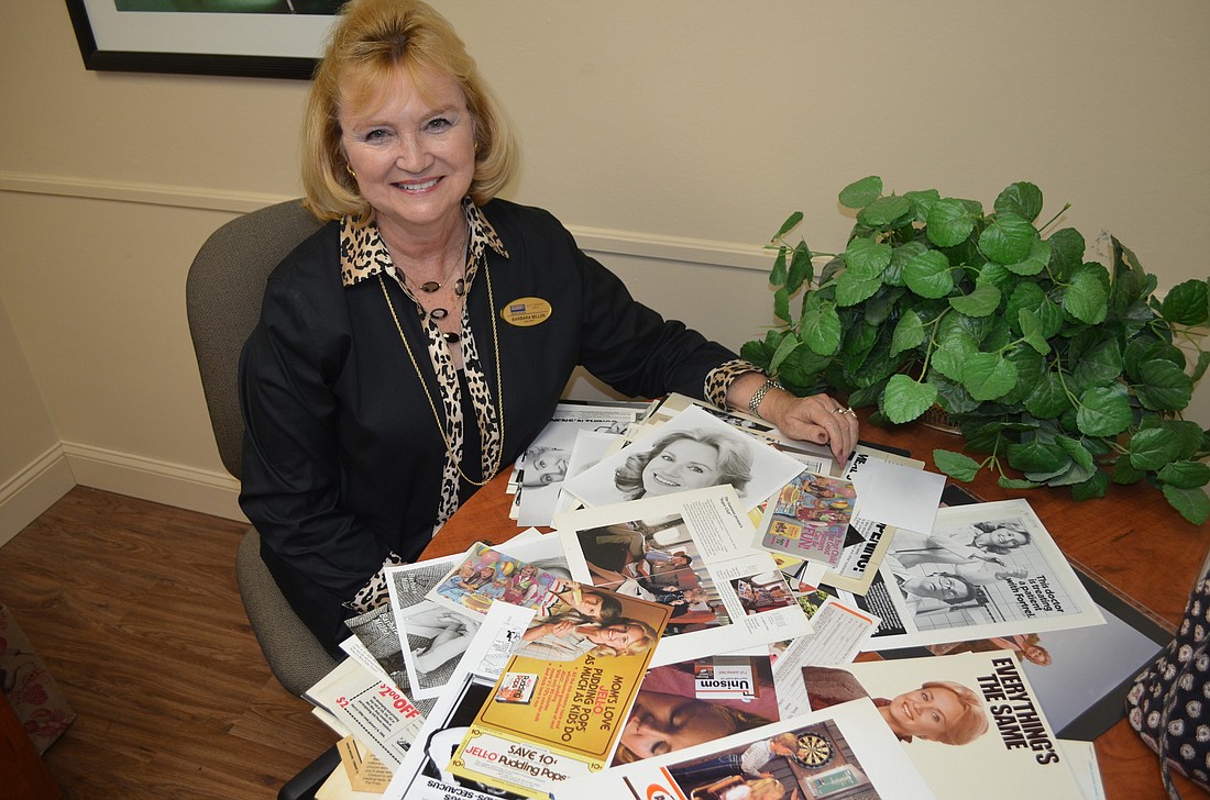 Harriet Sokmensuer Barbara Miller sits in her office on St. Armands surrounded by past modeling photos.