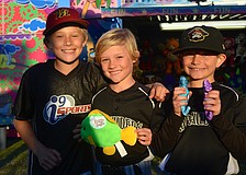 Alden Wright, 11, Isaac Wright, 8, and Jack Muller, 8, enjoy the festival after their baseball game.