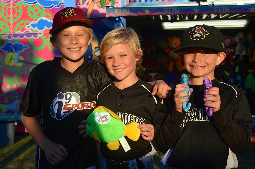 Alden Wright, 11, Isaac Wright, 8, and Jack Muller, 8, enjoy the festival after their baseball game.
