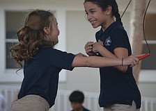Katherine N. and Divya M. jump together.