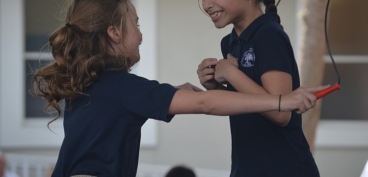 Katherine N. and Divya M. jump together.