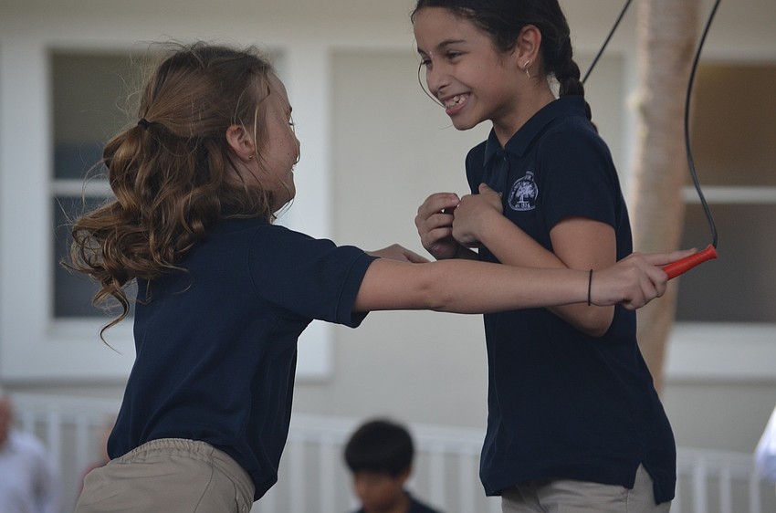 Katherine N. and Divya M. jump together.