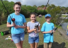 Gianna and Gabriella Pento fish with their friend Michael McQueeny.