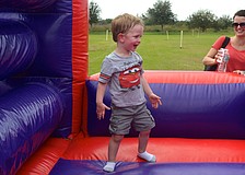 Two-year-old Kellan Jones plays around on an inflatable obstacle course.