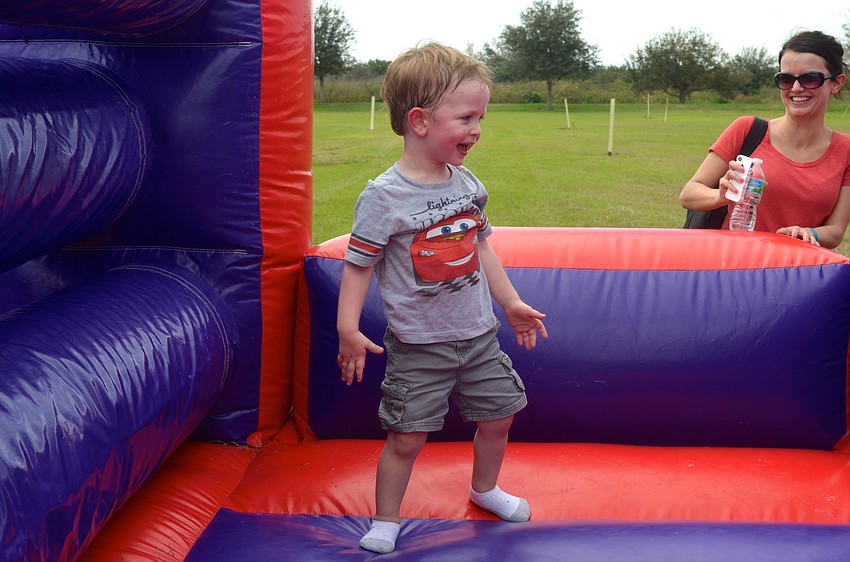 Two-year-old Kellan Jones plays around on an inflatable obstacle course.