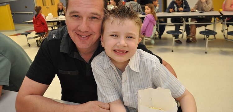 Jay Bell and his son, Jayden, 6, feast on popcorn.