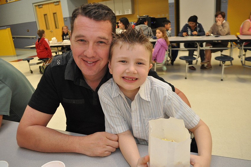Jay Bell and his son, Jayden, 6, feast on popcorn.