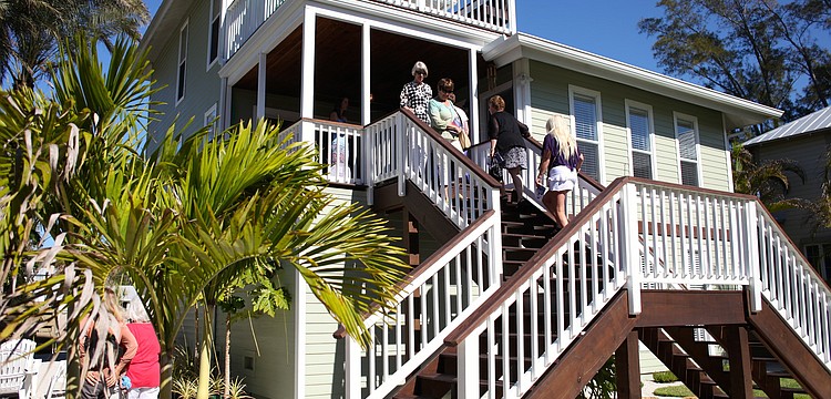 Home tour attendees filter in and out of the Barberâ€™s home, the first stop on the tour.