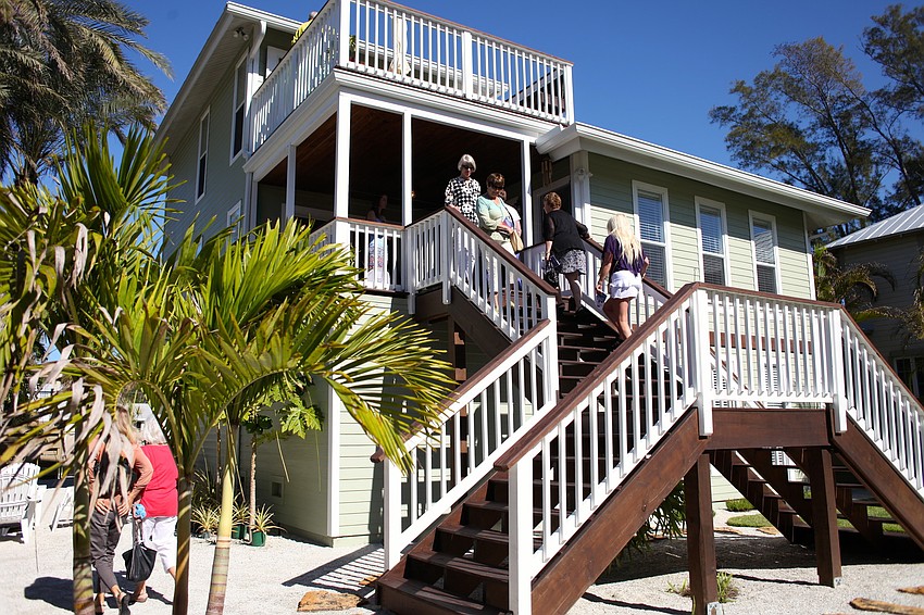 Home tour attendees filter in and out of the Barberâ€™s home, the first stop on the tour.