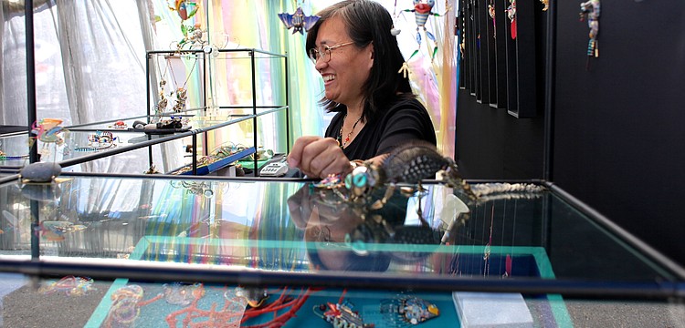 Cynthia Chuang of Jewelry10 laughs as her customers compliment her eccentric and colorful pieces.