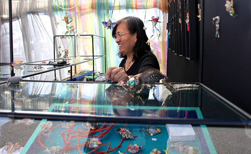 Cynthia Chuang of Jewelry10 laughs as her customers compliment her eccentric and colorful pieces.
