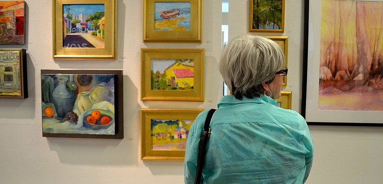 Kathie Troshynski looks at the work on display.
