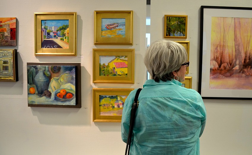Kathie Troshynski looks at the work on display.