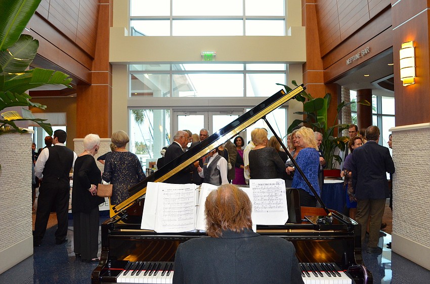 Gary DeMichele entertains attendees with the piano.