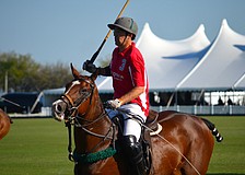 Chris Nevins chases after the ball during the polo match.