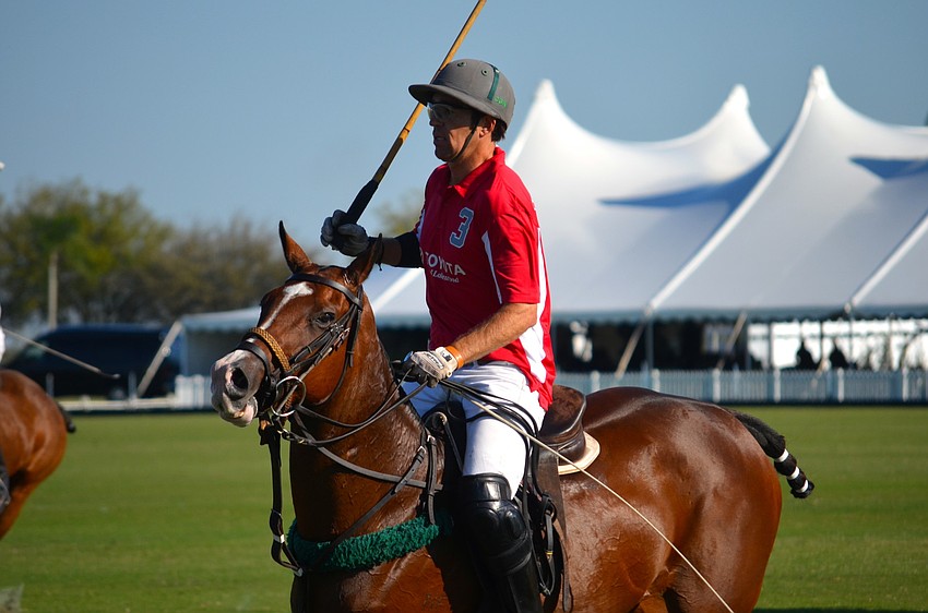 Chris Nevins chases after the ball during the polo match.