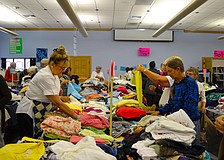 The womenâ€™s clothing section is a busy area during the sale.