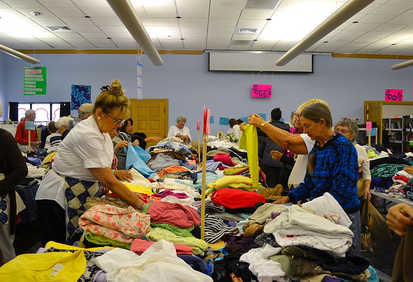 The womenâ€™s clothing section is a busy area during the sale.