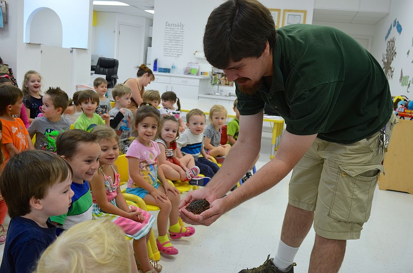 Head Curator of Sarasota Jungle Gardensâ€™ Animal Department Jeremiah Nichol shows students a Pacman frog.