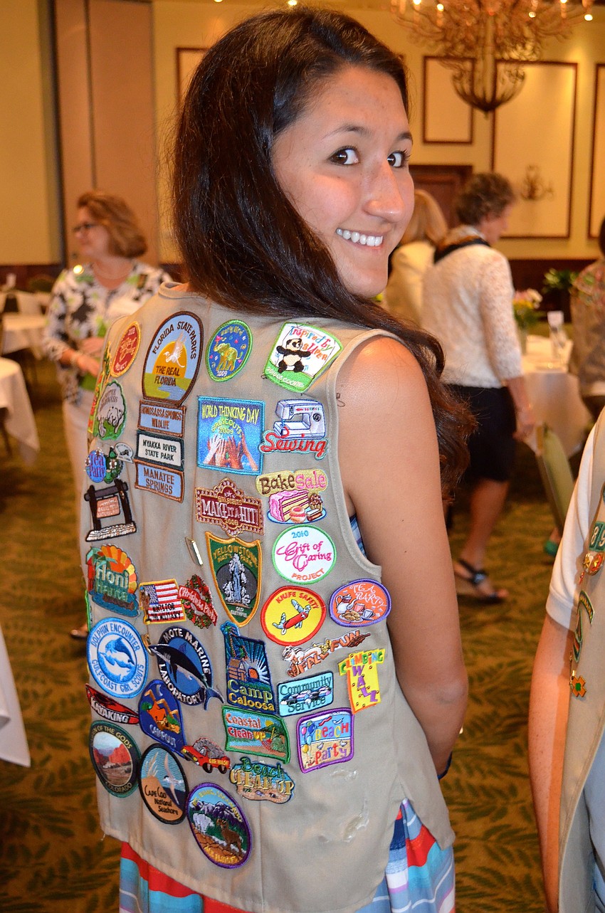 Lisa Fusco shows off her merit badges.