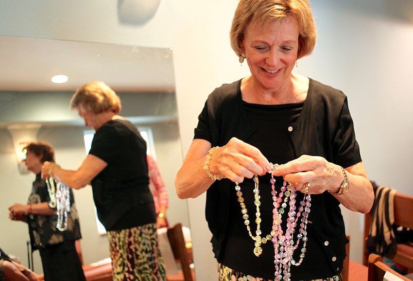 Charlotte Cooper prepares the jewelry for her first outfit before the show.