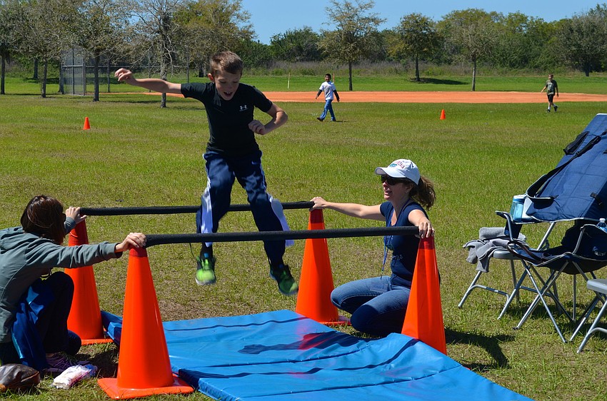 Ten-year-old Austin Parcels jumps during the schoolâ€™s obstacle course.