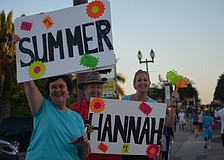 Suzanne and Dennis Plasse and daughter, Bethany Kasten, cheer on three family members.