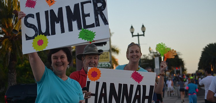 Suzanne and Dennis Plasse and daughter, Bethany Kasten, cheer on three family members.