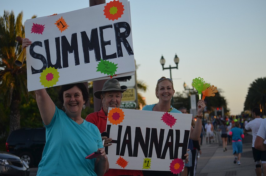 Suzanne and Dennis Plasse and daughter, Bethany Kasten, cheer on three family members.