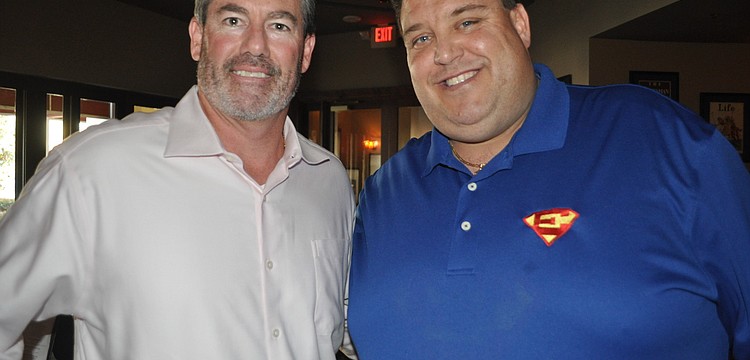 Jamie Dunnam of the David Gigliotti Legacy Foundation and Craig Livingston, whose son, Eddie, known as Super Eddie, passed away from cancer.
