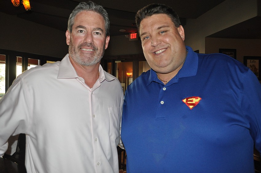 Jamie Dunnam of the David Gigliotti Legacy Foundation and Craig Livingston, whose son, Eddie, known as Super Eddie, passed away from cancer.