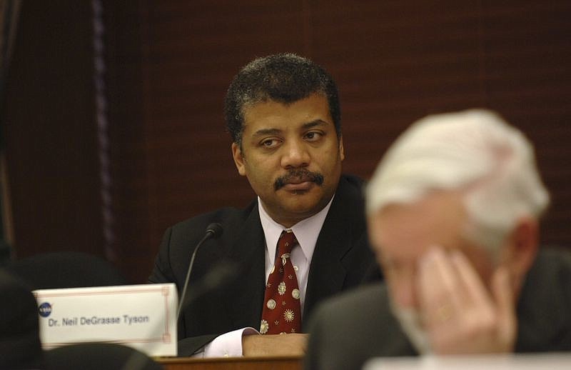 Neil deGrasse Tyson, an astrophysicist and director of the Hayden Planetarium, is known for his ability to simplify and communicate complex scientific theories during lectures.