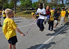 Daniel Clark, in white, jumps with friends.
