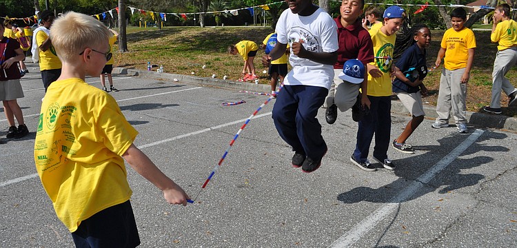 Daniel Clark, in white, jumps with friends.