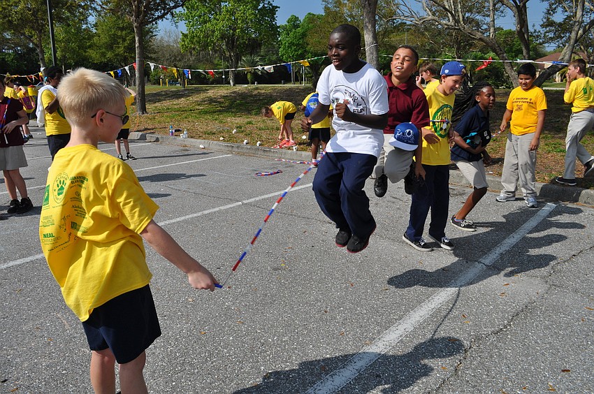 Daniel Clark, in white, jumps with friends.